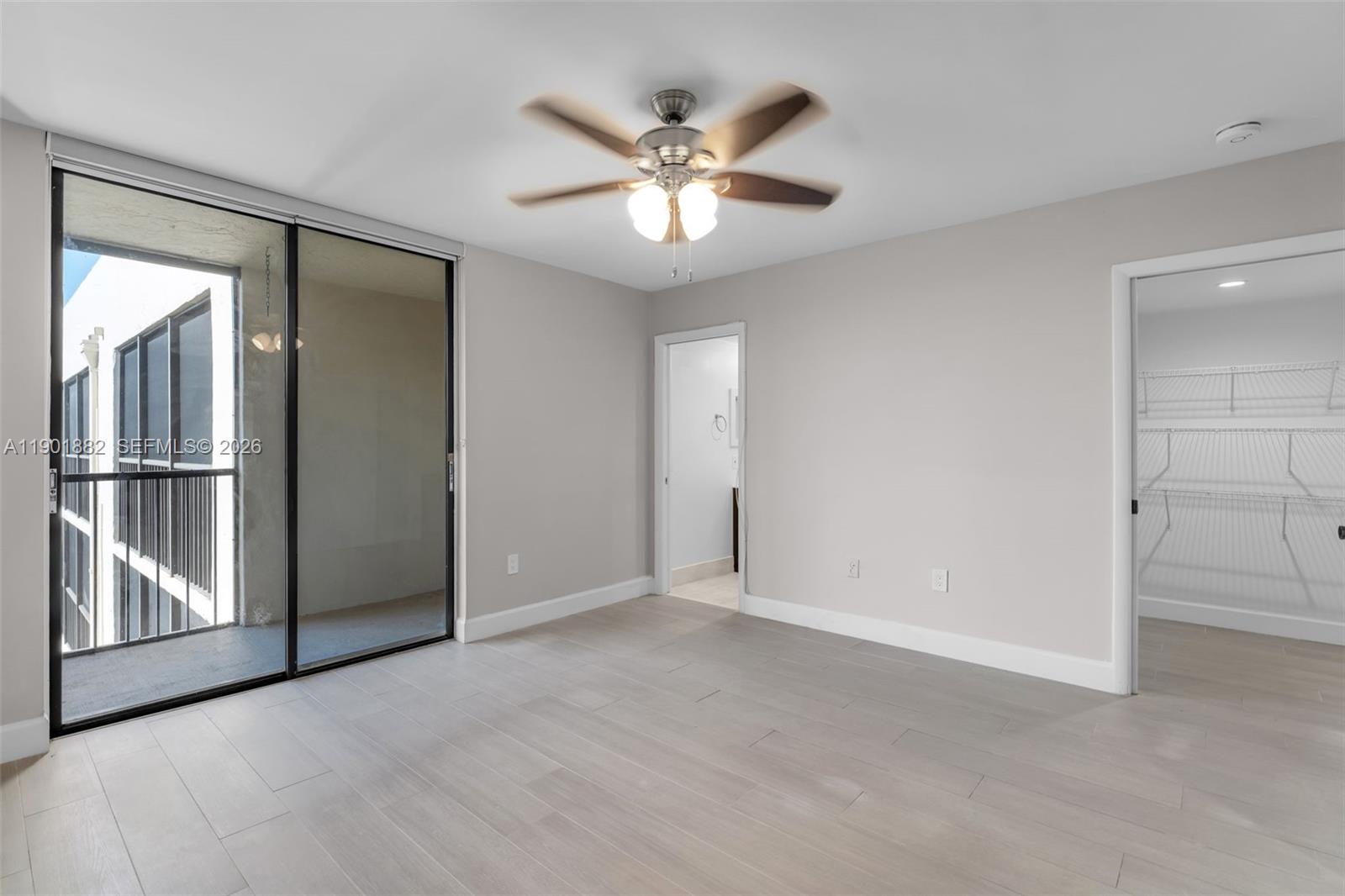 8045 Southwest 107th Avenue, Unit 303 Miami, FL 33173 - Photo 16 of 37 a view of an empty room with a ceiling fan