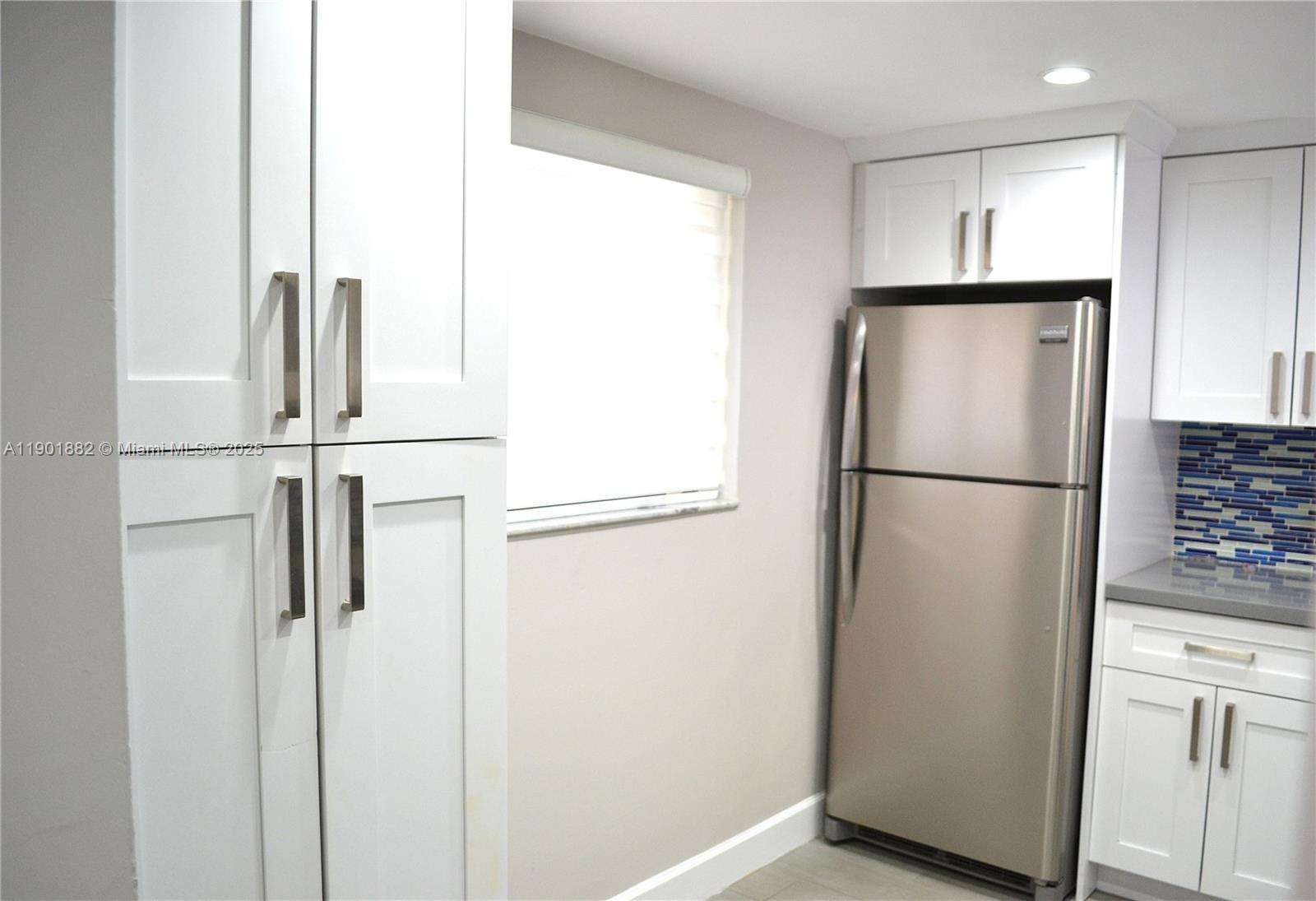 8045 Southwest 107th Avenue, Unit 303 Miami, FL 33173 - Photo 2 of 26 a view of kitchen with refrigerator and wooden floor