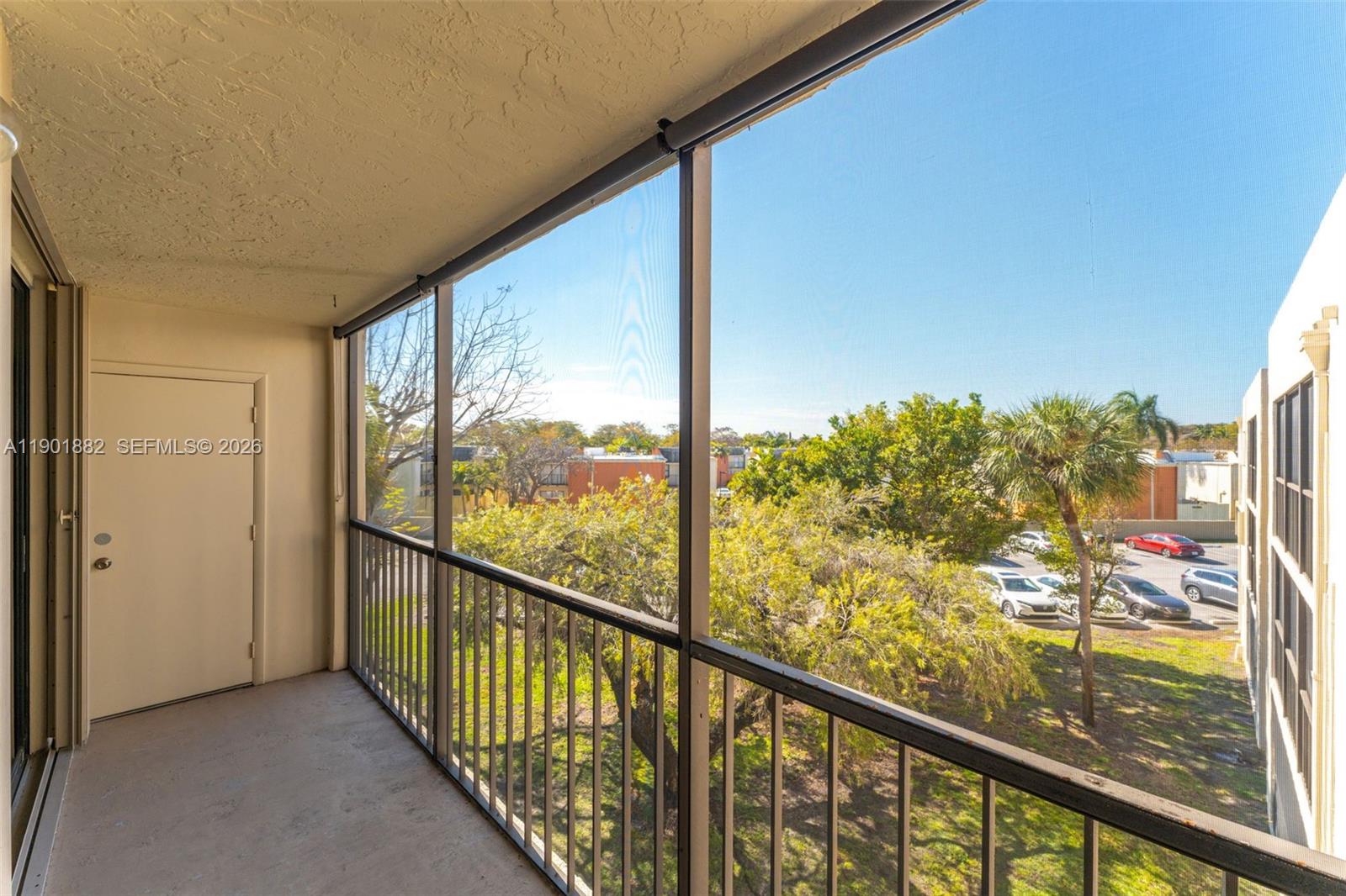 8045 Southwest 107th Avenue, Unit 303 Miami, FL 33173 - Photo 24 of 37 a view of a balcony with wooden floor