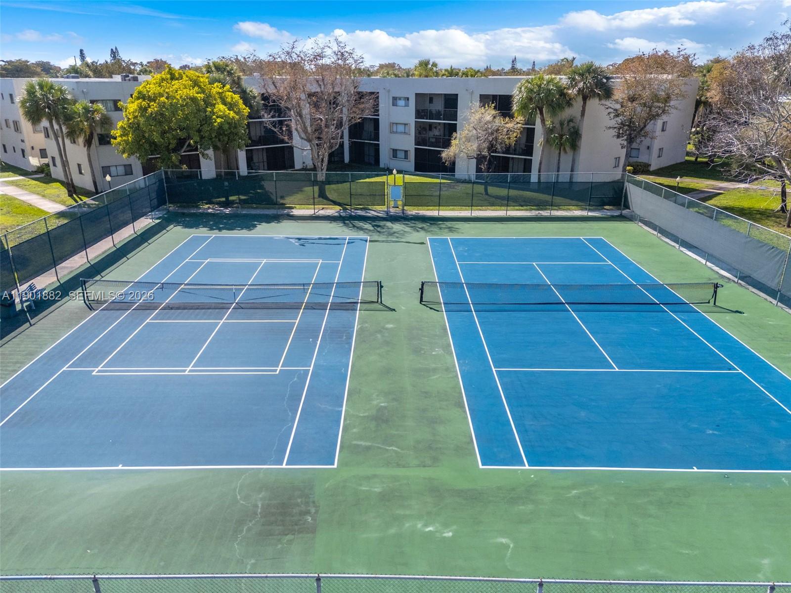 8045 Southwest 107th Avenue, Unit 303 Miami, FL 33173 - Photo 35 of 37 a view of swimming pool with lawn chairs and large trees