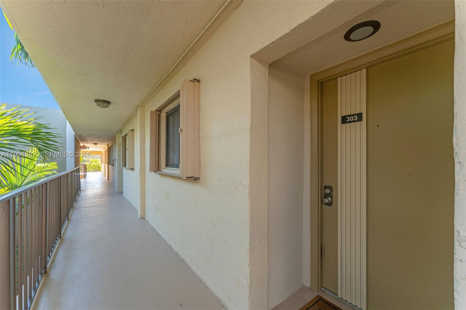 8045 Southwest 107th Avenue, Unit 303 Miami, FL 33173 - Photo 6 of 37 a view of a hallway with wooden floor and stairs