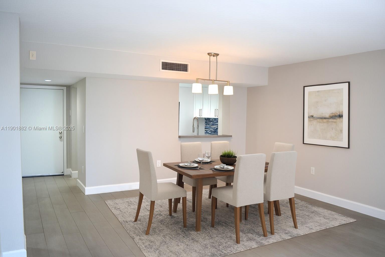 8045 Southwest 107th Avenue, Unit 303 Miami, FL 33173 - Photo 7 of 26 a view of a dining room with furniture and wooden floor