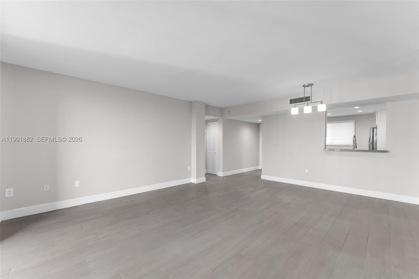 8045 Southwest 107th Avenue, Unit 303 Miami, FL 33173 - Photo 8 of 37 a view of an empty room with a kitchen