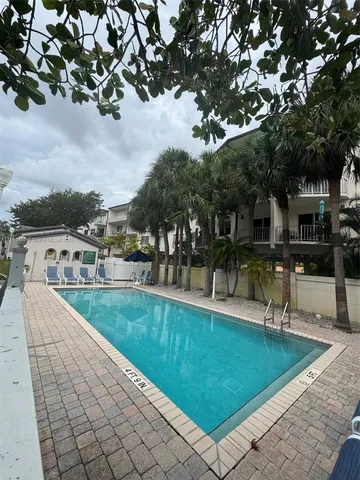 a view of a swimming pool and lounge chairs