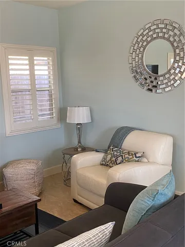 a bedroom with a bed mirror and a window