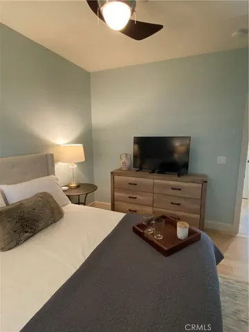 a bedroom with furniture and a flat screen tv