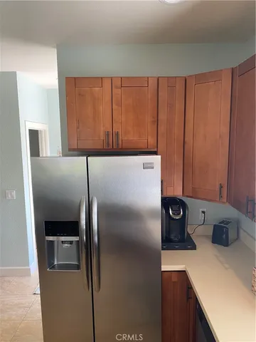 a kitchen with a refrigerator and a stove