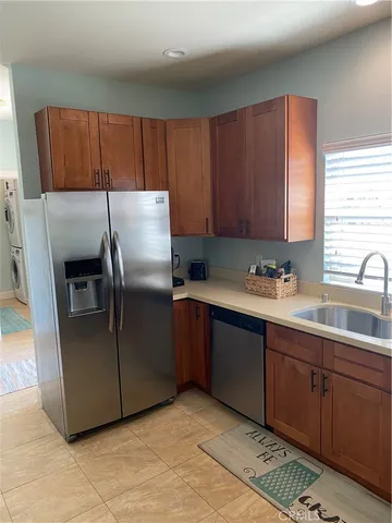 a kitchen with stainless steel appliances granite countertop a refrigerator and a sink