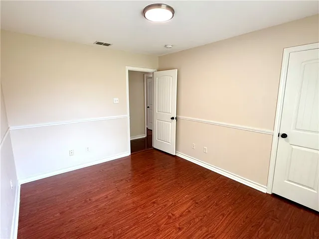 an empty room with wooden floor