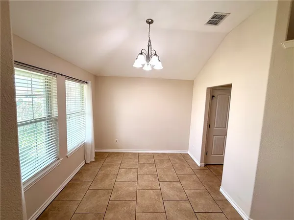 a view of a room with a window and chandelier