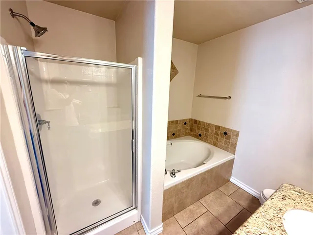 a bathroom with a tub and shower