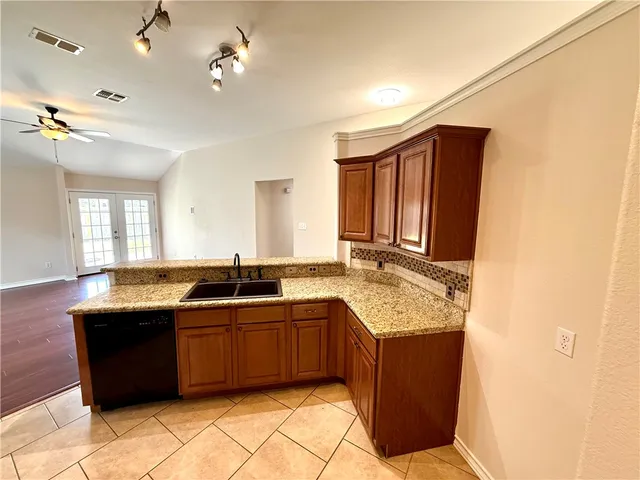 a kitchen with a sink a counter top space and appliances
