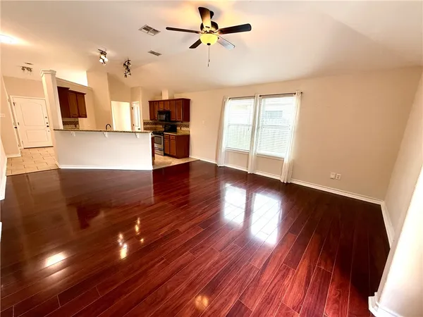 a view of a kitchen with wooden floor and a kitchen