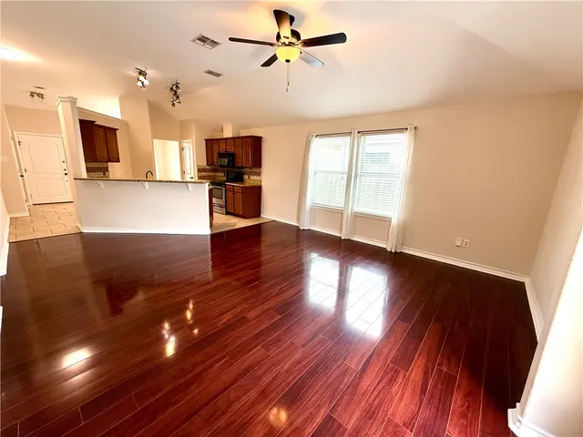 a view of a kitchen with wooden floor and a kitchen
