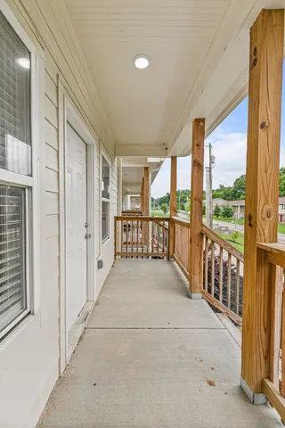 a view of a porch with wooden floor and stairs