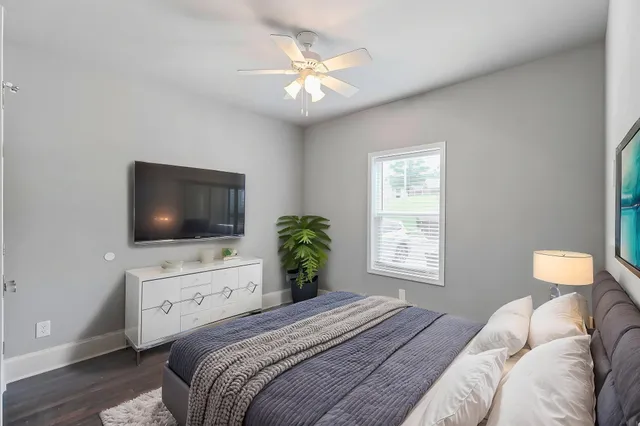 a bedroom with a bed and a flat screen tv