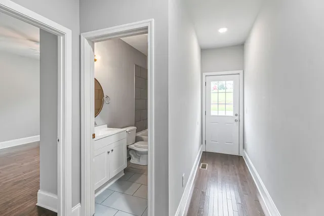 a view of a bathroom from a hallway