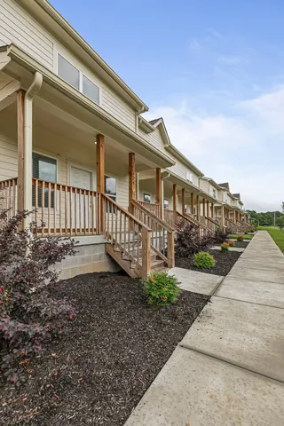 a view of a house with backyard and porch