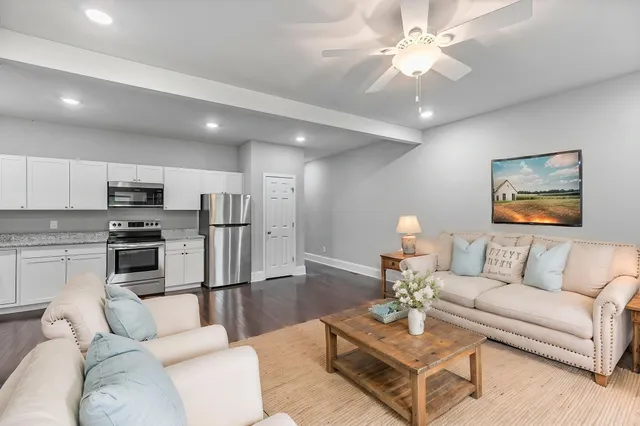 a living room with furniture and kitchen view