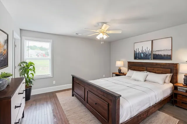 a bedroom with a bed chandelier and a window