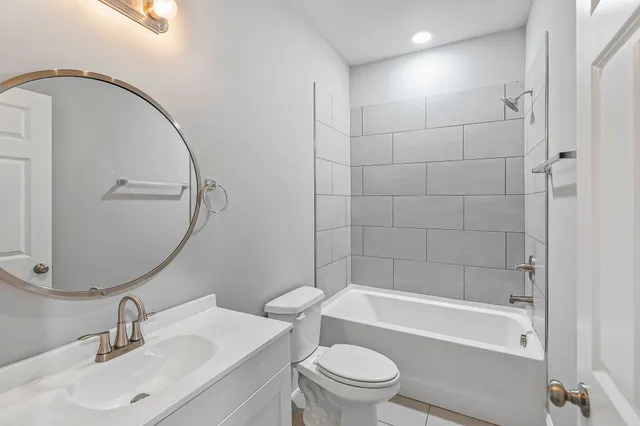 a bathroom with a sink toilet and shower