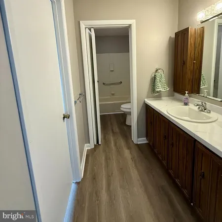 a bathroom with a double vanity sink and a mirror