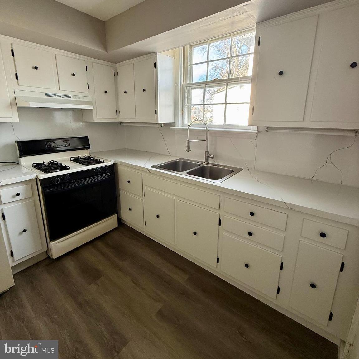 1643 Pennington Road Ewing, NJ 08618 - Photo 5 of 12 a kitchen with cabinets appliances a sink and a window