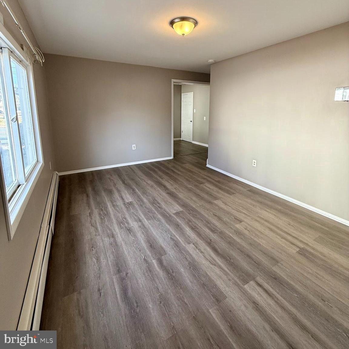 1643 Pennington Road Ewing, NJ 08618 - Photo 8 of 12 wooden floor in an empty room with a window