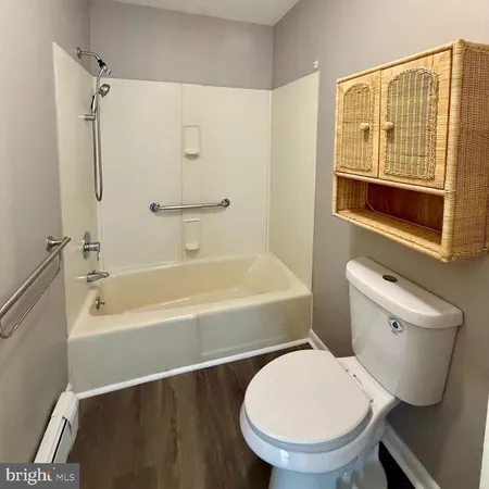 a bathroom with a toilet a sink and bathtub
