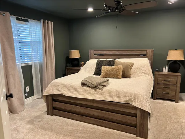 a bedroom with a bed and a night stand