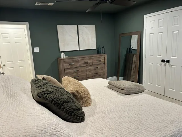 a bedroom with a bed and a dresser