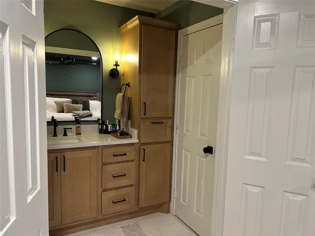 a bathroom with a sink vanity and a mirror