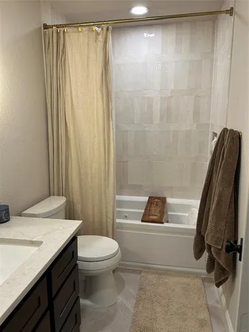 a bathroom with a sink a toilet and a shower