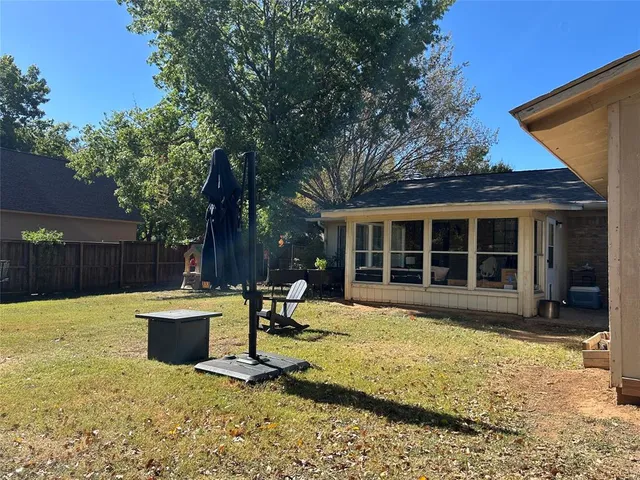 a view of a house with backyard and sitting area