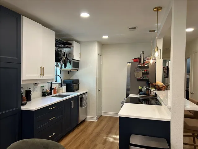 a kitchen with a sink stove and refrigerator