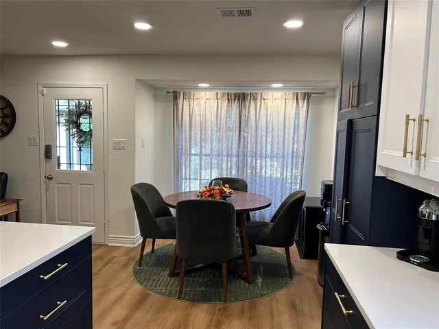 a view of a dining room with furniture and window