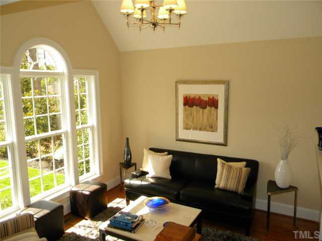 3704 Laurel Hills Road Raleigh, NC 27612 - Photo 4 of 25 Enjoy visiting with your friends in this inviting living room with cathedral ceiling, fireplace and two-tier chandelier Living Room