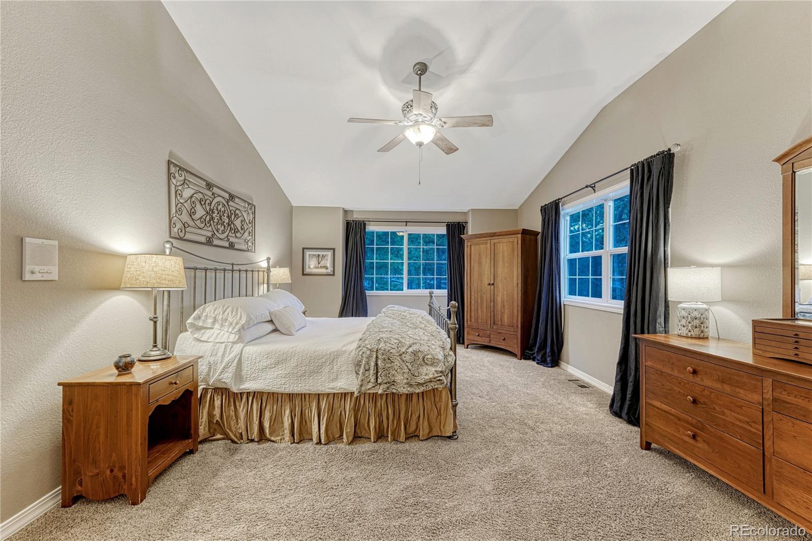 18150 Bakers Farm Road Colorado Springs, CO 80908 - Photo 19 of 49 a bed room with a bed and a dresser