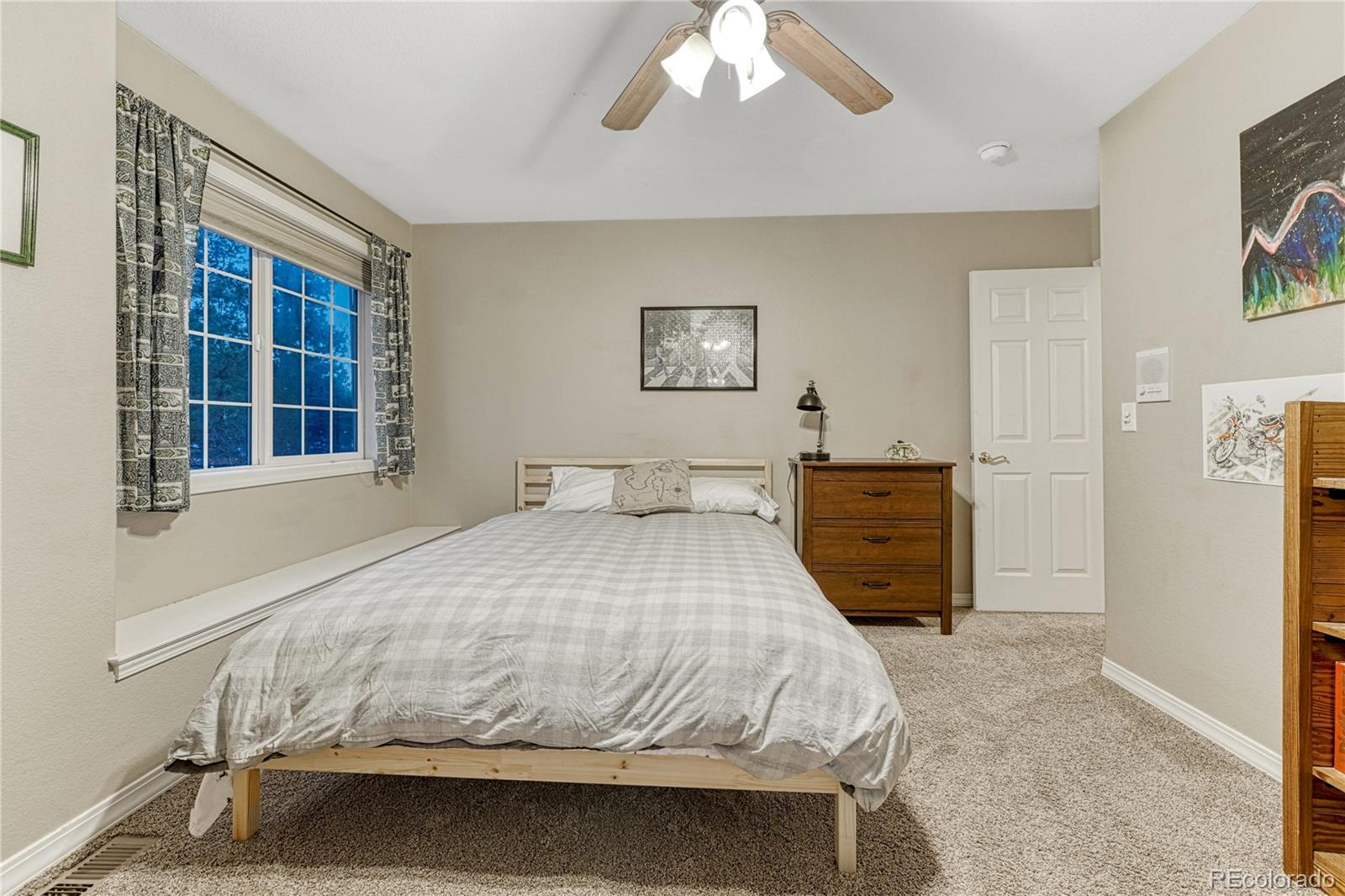 18150 Bakers Farm Road Colorado Springs, CO 80908 - Photo 25 of 49 a bedroom with a bed and a window