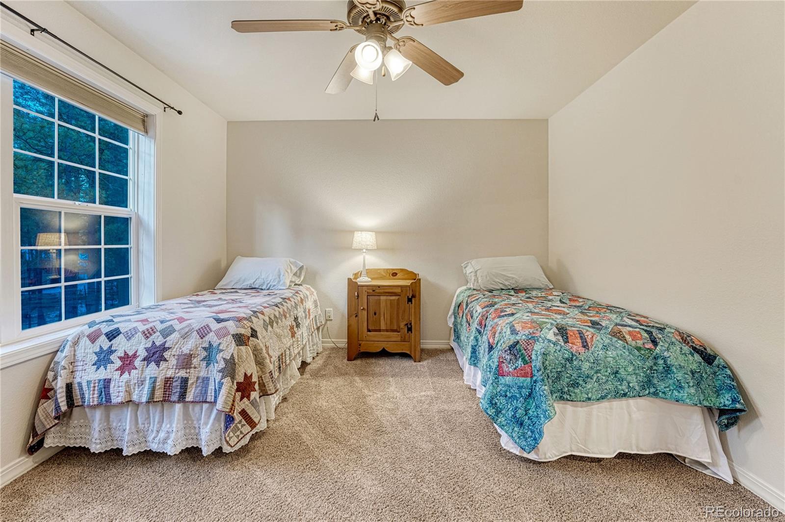 18150 Bakers Farm Road Colorado Springs, CO 80908 - Photo 26 of 49 a bedroom with a bed and a window