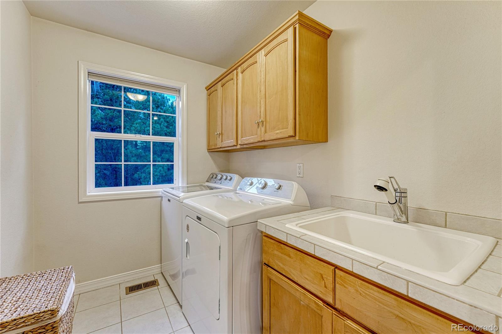 18150 Bakers Farm Road Colorado Springs, CO 80908 - Photo 30 of 49 a utility room with a sink washer and dryer