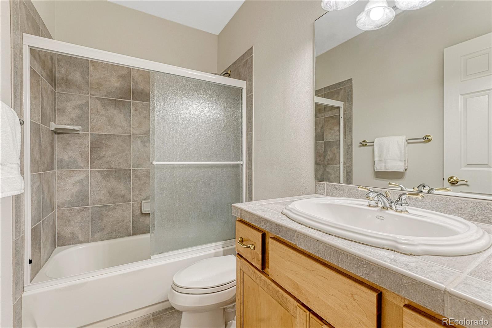 18150 Bakers Farm Road Colorado Springs, CO 80908 - Photo 33 of 49 a bathroom with a sink a toilet and shower
