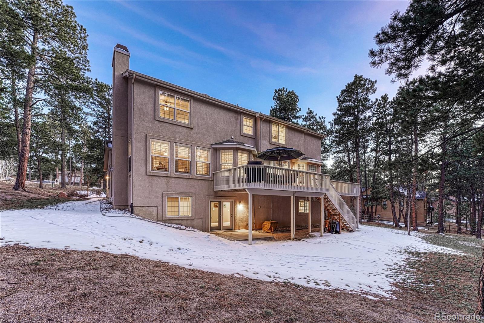 18150 Bakers Farm Road Colorado Springs, CO 80908 - Photo 41 of 49 a front view of a house with a yard