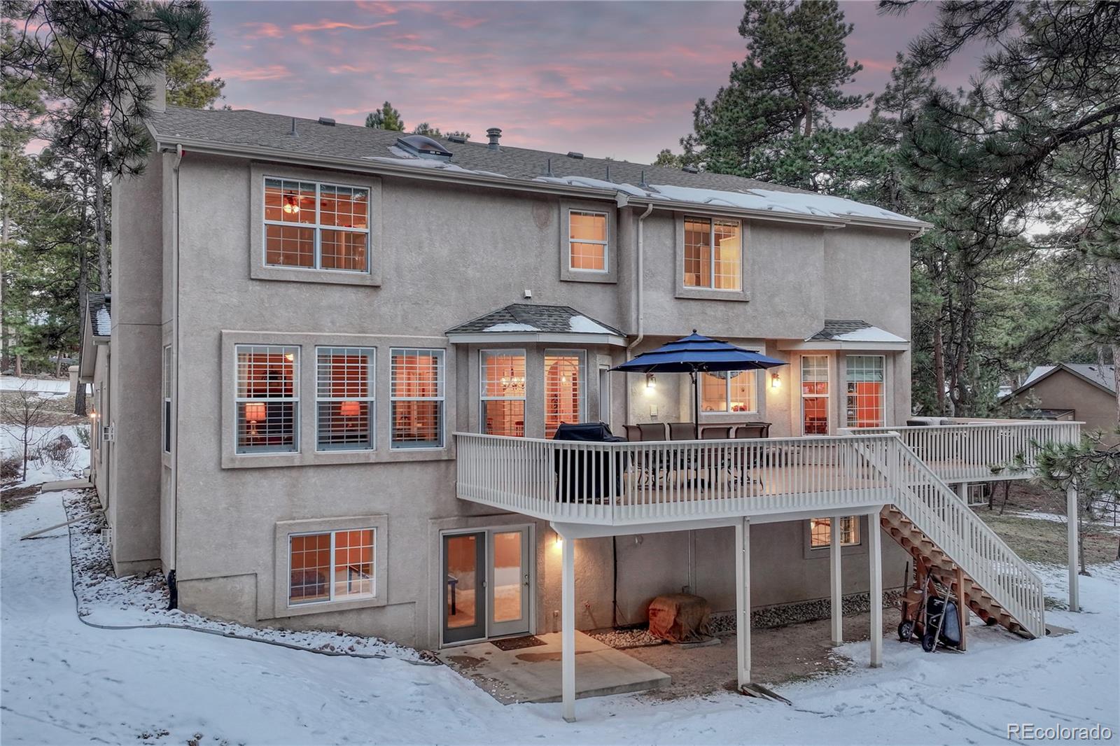 18150 Bakers Farm Road Colorado Springs, CO 80908 - Photo 43 of 49 a front view of a residential apartment building with a yard