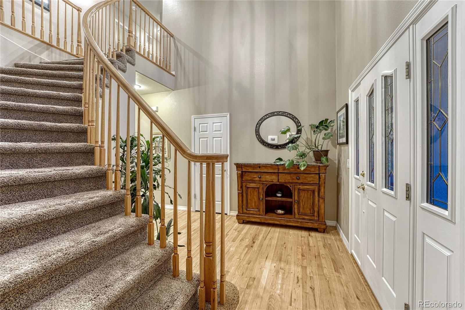 18150 Bakers Farm Road Colorado Springs, CO 80908 - Photo 5 of 49 a view of a hallway with wooden floor and staircase