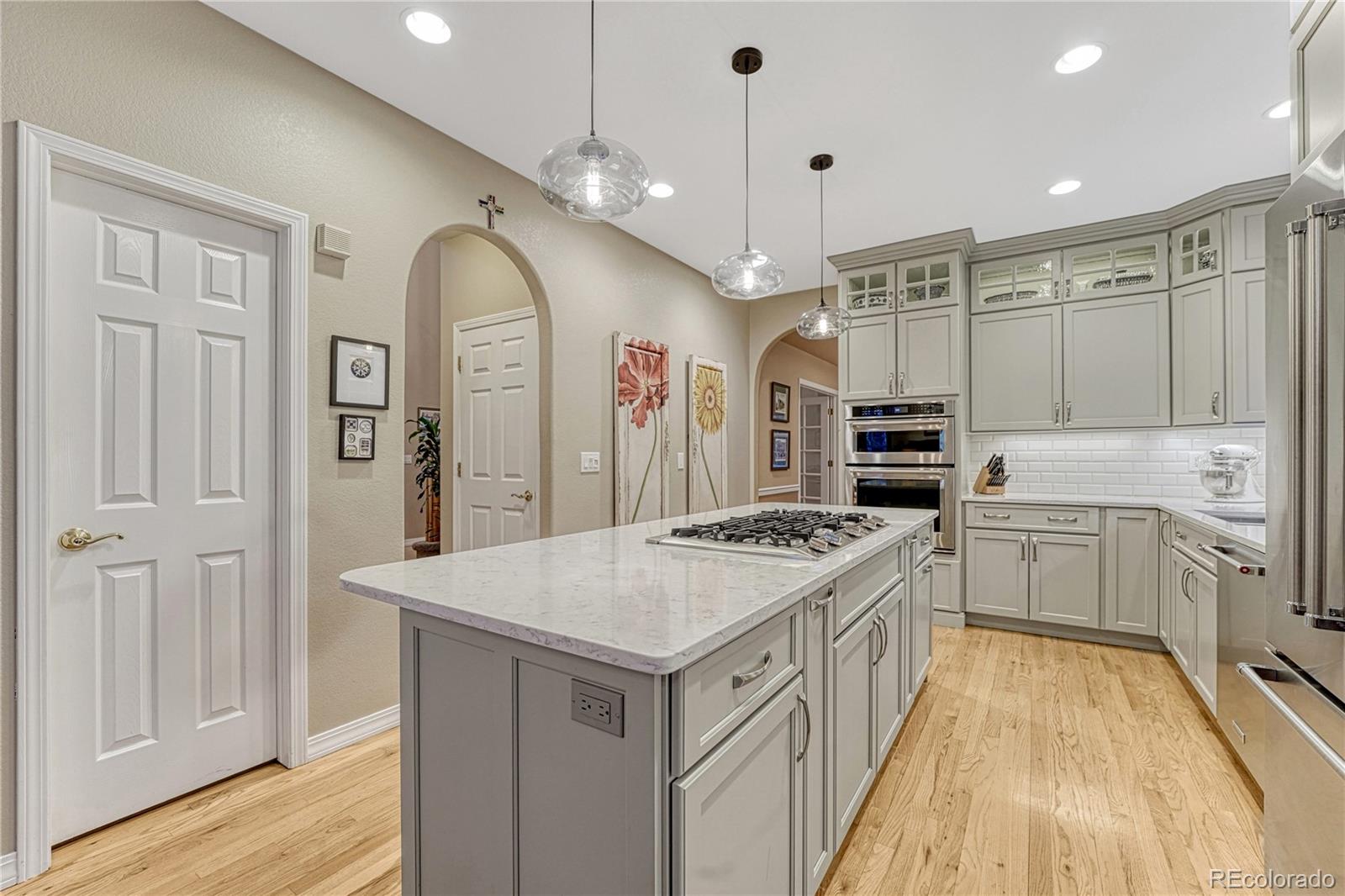 18150 Bakers Farm Road Colorado Springs, CO 80908 - Photo 7 of 49 a kitchen with a stove a sink a refrigerator and a fireplace
