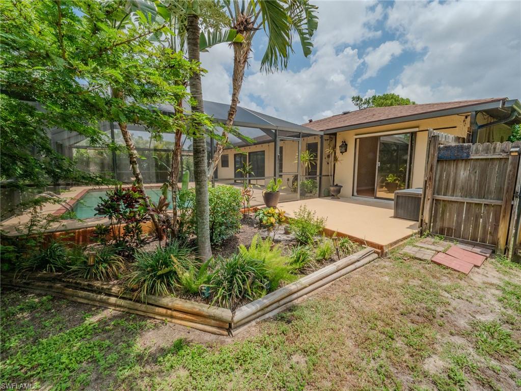 18414 Tulip Road Fort Myers, FL 33967 - Photo 34 of 37 Screened-in pool area featuring a patio deck and mature landscaping