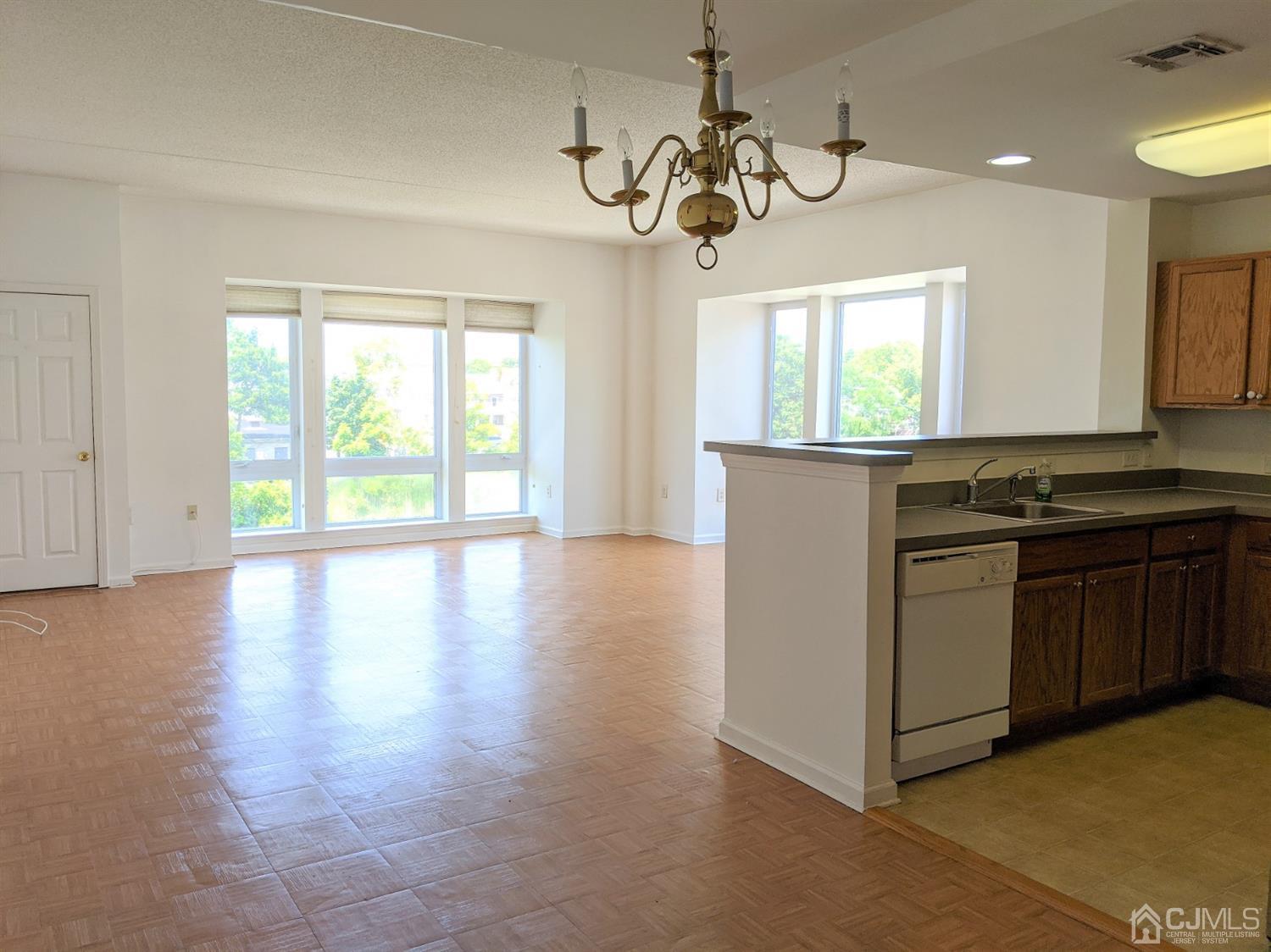 358 Rector Street, Unit 504 Perth Amboy, NJ 08861 - Photo 3 of 18 a kitchen with a stove a sink and a window