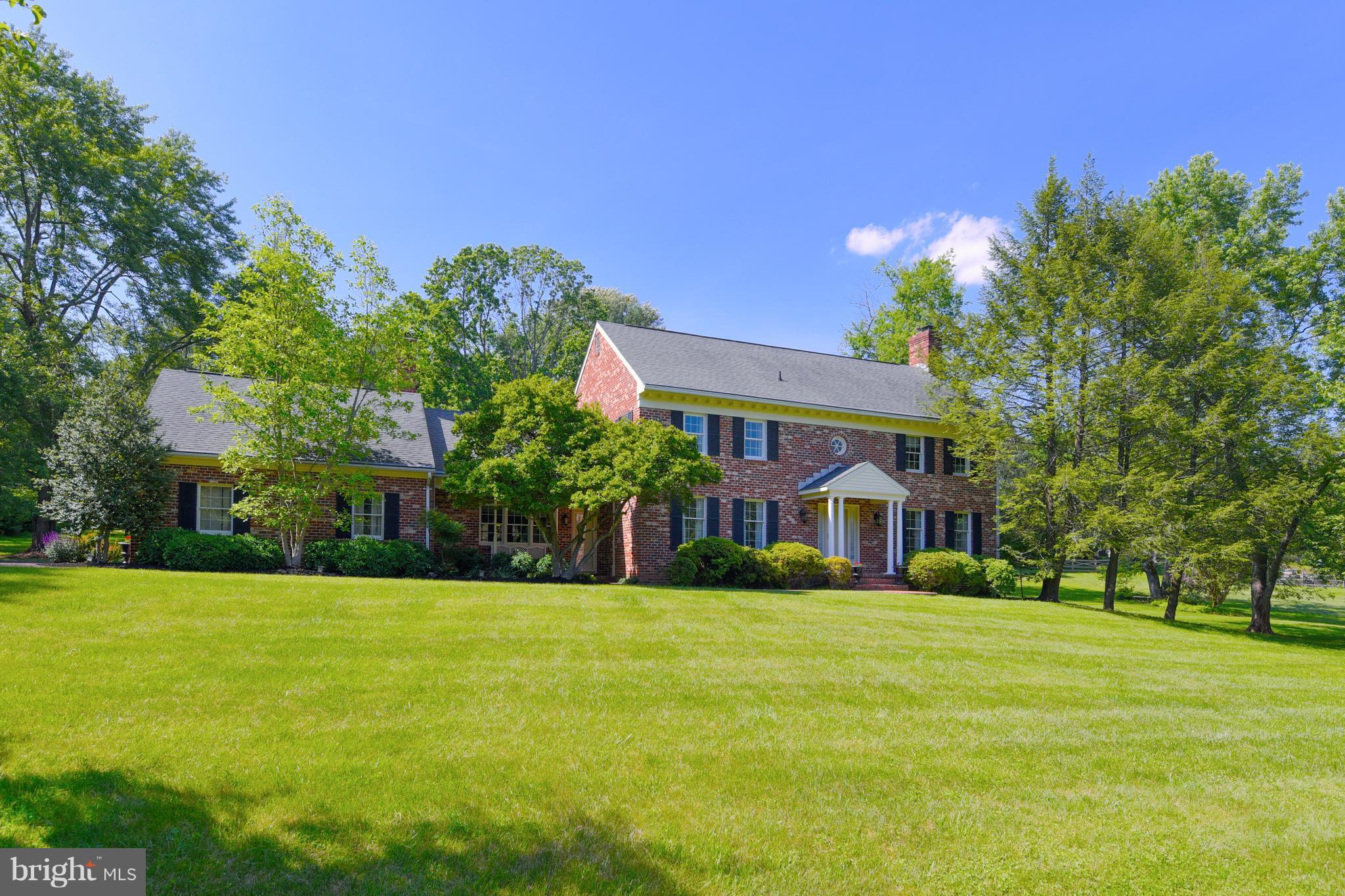 a view of house with yard and green space