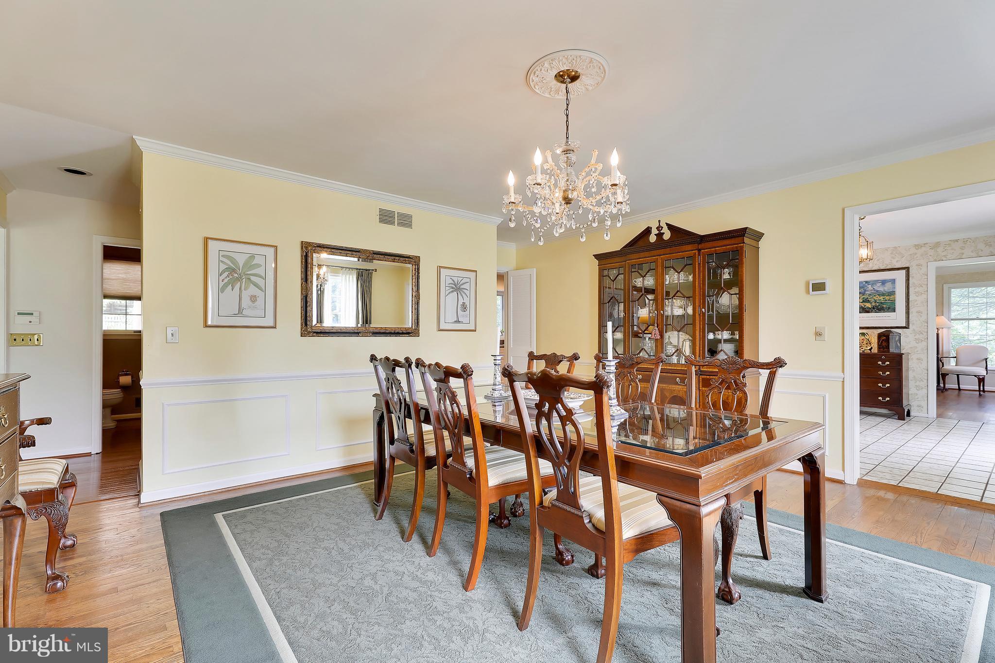 13402 Cambria Farms Road Phoenix, MD 21131 - Photo 16 of 28 a view of a dining room with furniture and chandelier